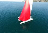 red gennaker turquoise crew white sailing yacht neel 45